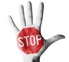 Hand raised with stop sign painted - isolated on white background